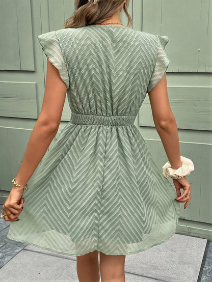 Vrouwelijke Chevron Jurk met Kant en Strik Detail