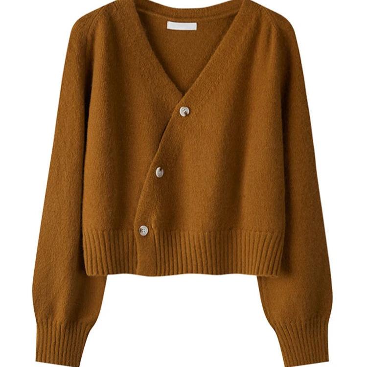 Alora trui in een warme karamelkleur met een moderne asymmetrische knoopsluiting. De trui heeft lange mouwen, een ribgebreide taille en een eigentijdse pasvorm. Ideaal voor een stijlvolle en comfortabele uitstraling.