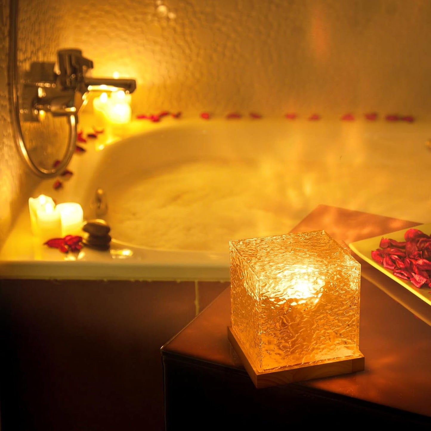 Lumeo Cube lamp in warme gouden kleur, vastgehouden in de hand, met magische lichteffecten die op de muur schijnen, verlicht door een houten basis.